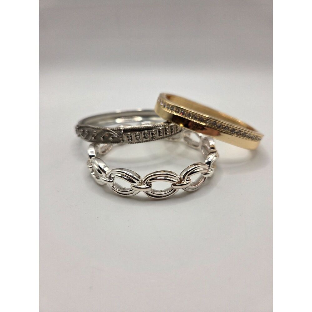 1799. Set of Three Metal Tone Bangle Bracelets